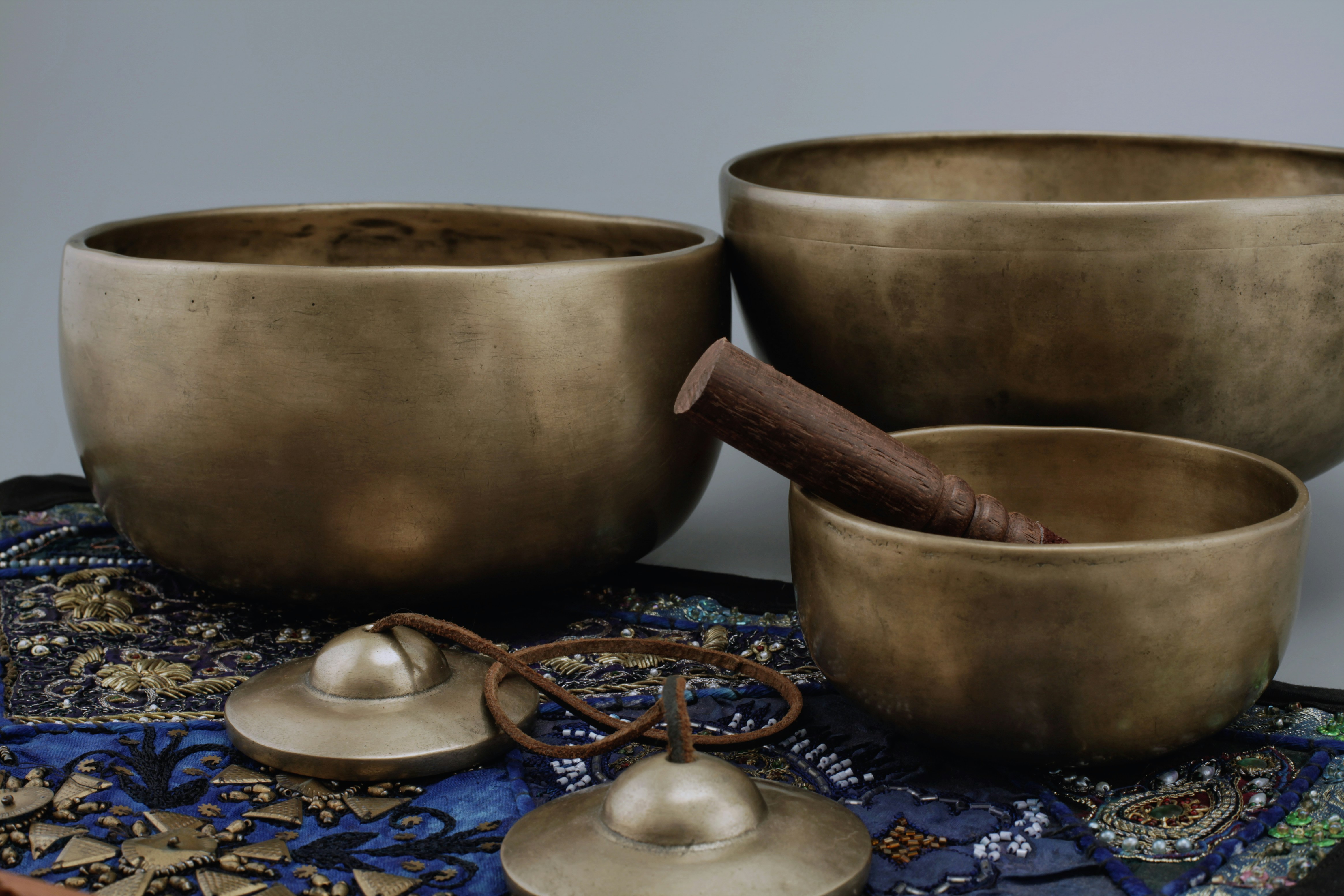 Collection of Jambati singing bowls in multiple sizes with mallet and tingsha cymbals