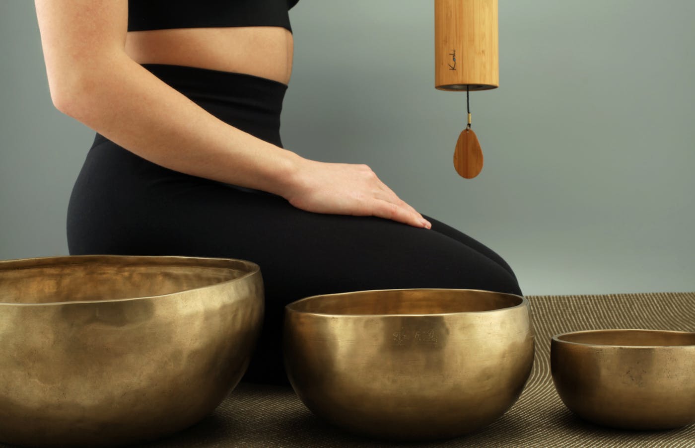 A collection of hand-hammered Jambati singing bowls in warm bronze tones